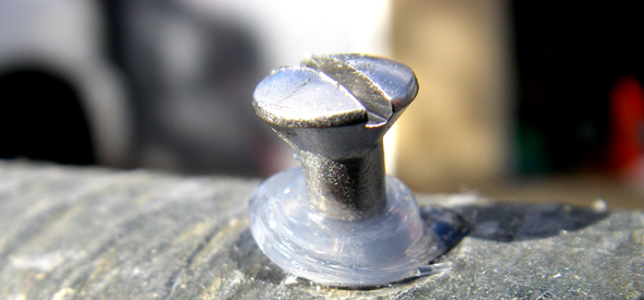 caulk-and-screw Insert the new blade, hit the hole with some waterproof caulk and replace the screw.